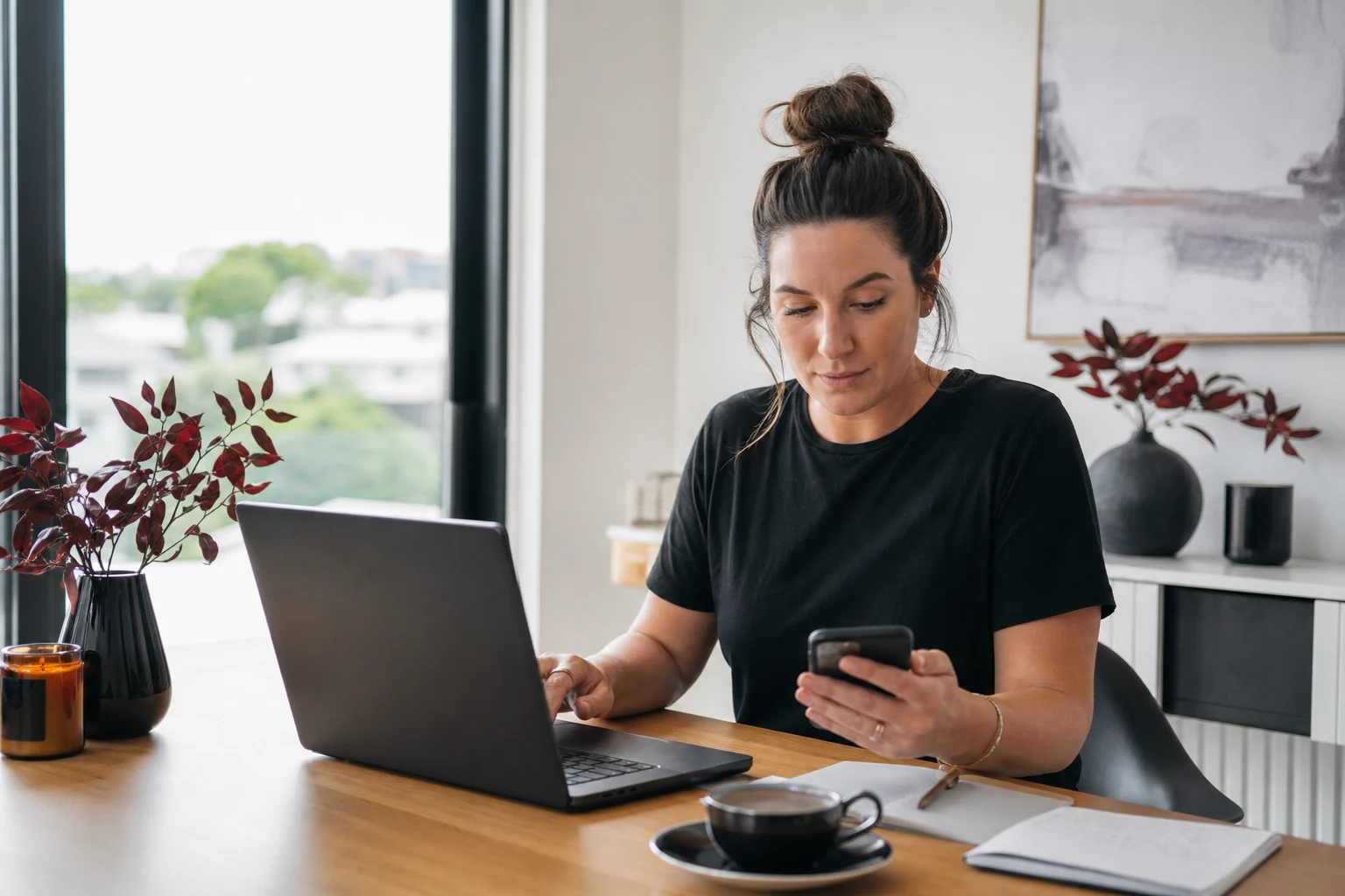 Business owner reviews automated email and social campaigns at her desk
